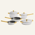 Experience culinary excellence with the Titanium Pro Cookware Set + Braiser, featuring five premium stainless steel pieces with luxurious gold handles and lids. Artfully arranged on a plain background, this elegant cookware set offers exceptional durability and a sophisticated touch for any modern kitchen.